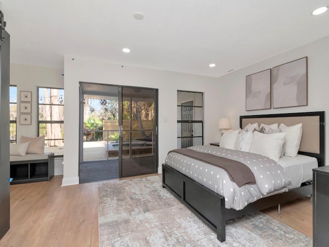 bedroom with access to exterior, recessed lighting, and wood finished floors