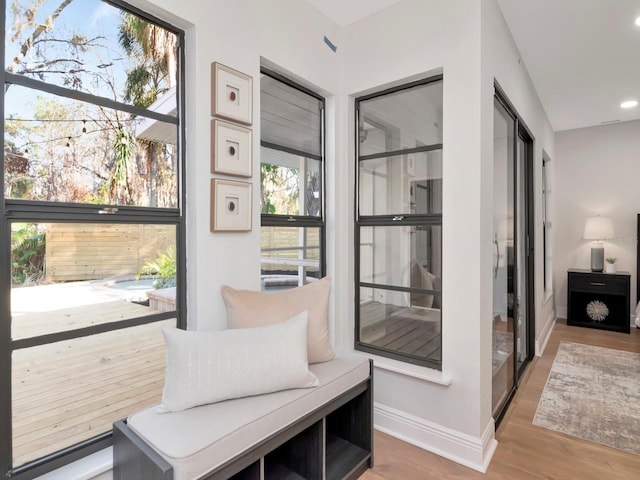 interior space featuring baseboards, wood finished floors, and recessed lighting