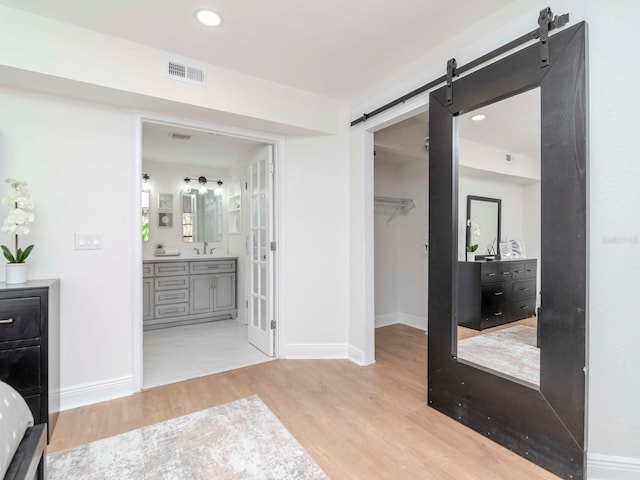 interior space featuring baseboards, visible vents, wood finished floors, and vanity