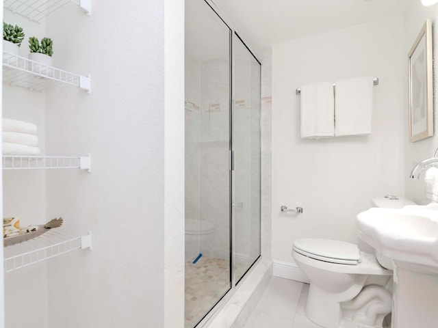 full bath with toilet, a stall shower, baseboards, and tile patterned floors