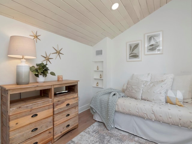 bedroom featuring lofted ceiling, wooden ceiling, wood finished floors, and visible vents