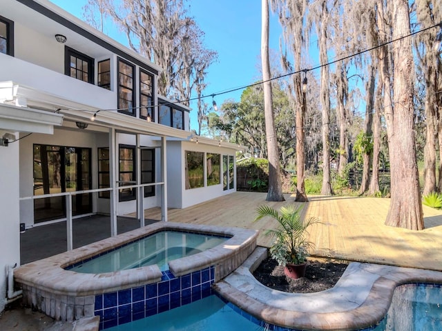 pool featuring an in ground hot tub and a patio area