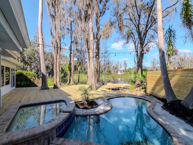 view of pool featuring a deck and an in ground hot tub