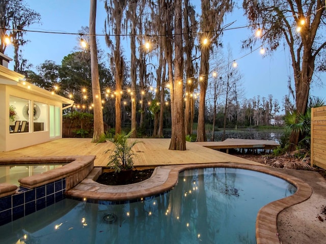 outdoor pool featuring an in ground hot tub