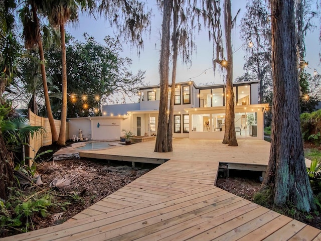 exterior space with a fenced backyard, a deck, and stucco siding