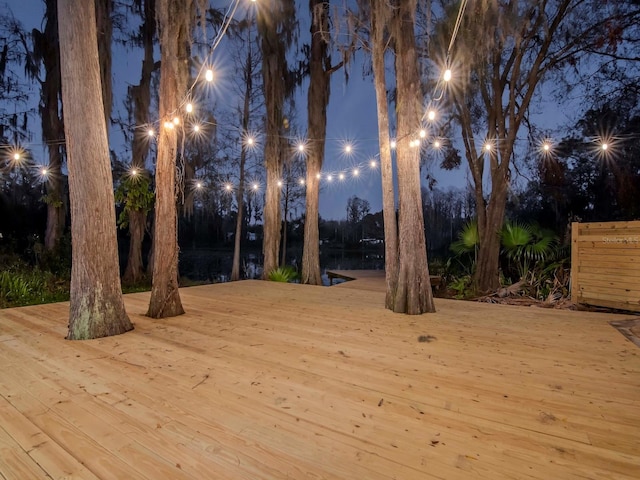 yard at night featuring a deck