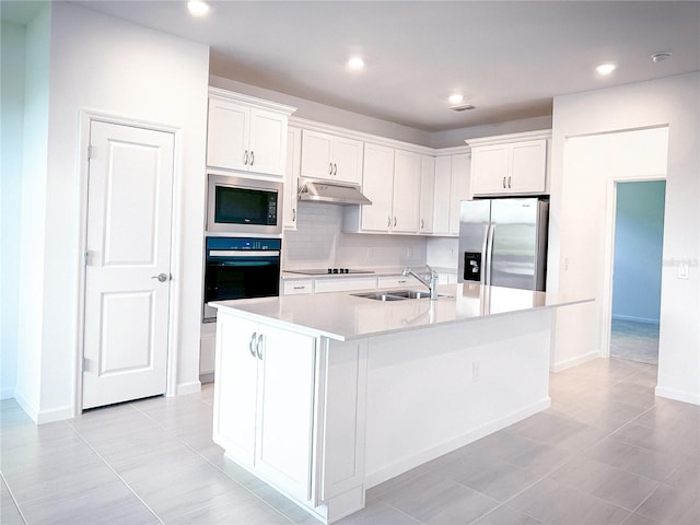 kitchen with backsplash, under cabinet range hood, white cabinets, black appliances, and a sink