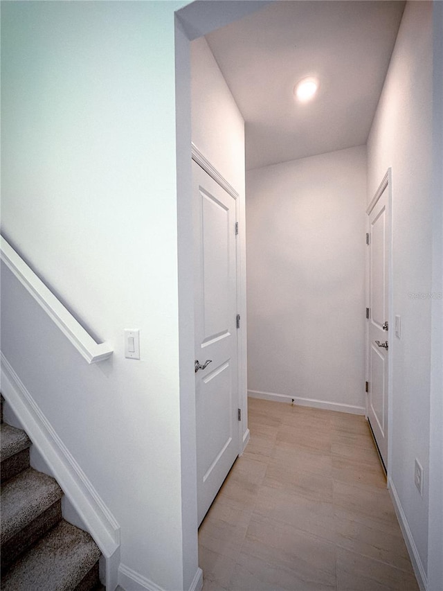 hall with stairway and baseboards