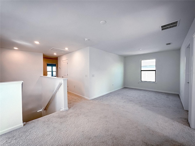 carpeted empty room with visible vents, recessed lighting, attic access, and baseboards