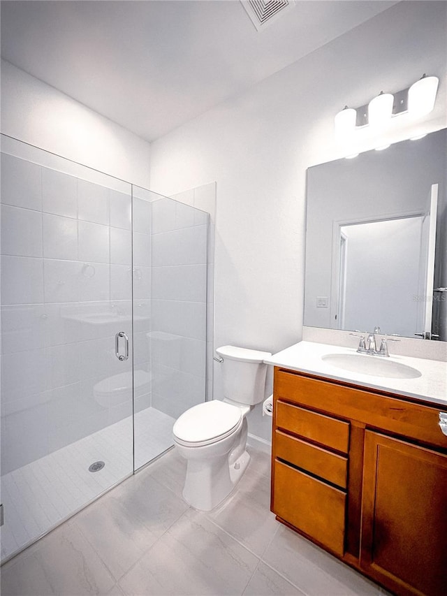 bathroom featuring visible vents, tiled shower, toilet, and vanity