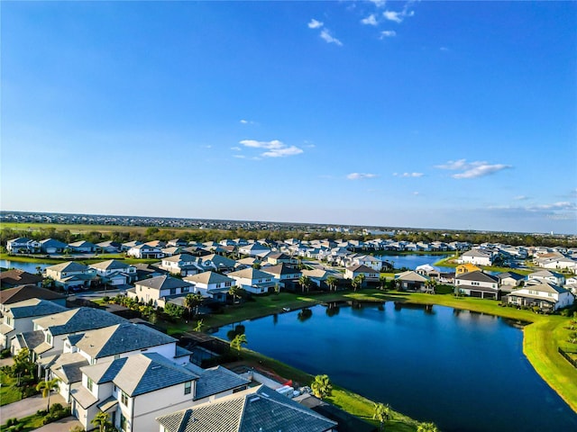 drone / aerial view with a residential view and a water view