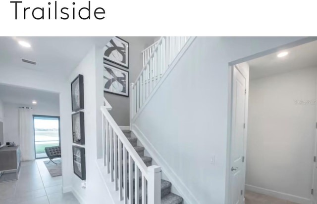 stairs with tile patterned floors, recessed lighting, visible vents, and baseboards