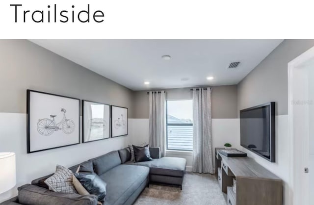 living area with recessed lighting, visible vents, and light colored carpet