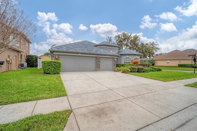 view of front of home featuring concrete driveway, a front lawn, and an attached garage