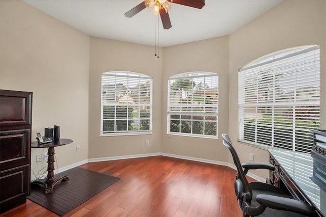 home office featuring ceiling fan, baseboards, and wood finished floors