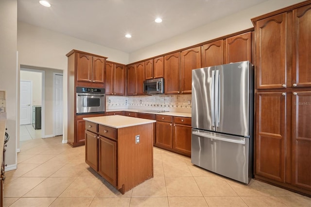 kitchen featuring light tile patterned floors, stainless steel appliances, a kitchen island, light countertops, and decorative backsplash