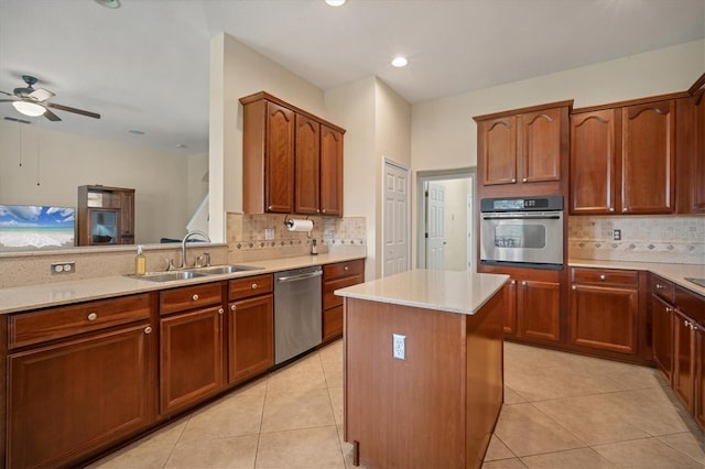 kitchen with tasteful backsplash, light countertops, stainless steel appliances, a sink, and light tile patterned flooring