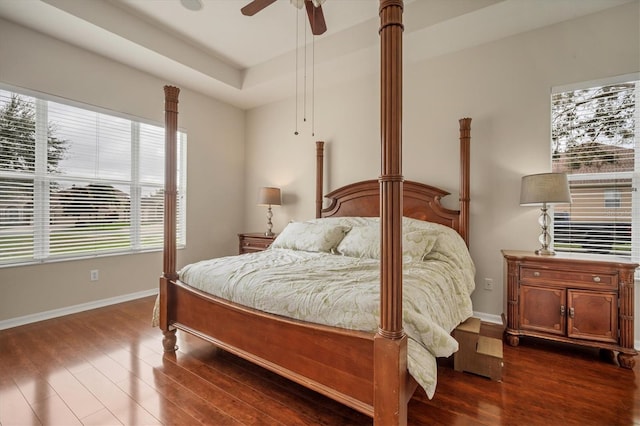 bedroom with dark wood-style floors, baseboards, and a ceiling fan