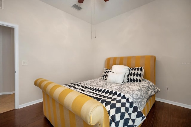 bedroom featuring baseboards, visible vents, ceiling fan, and wood finished floors