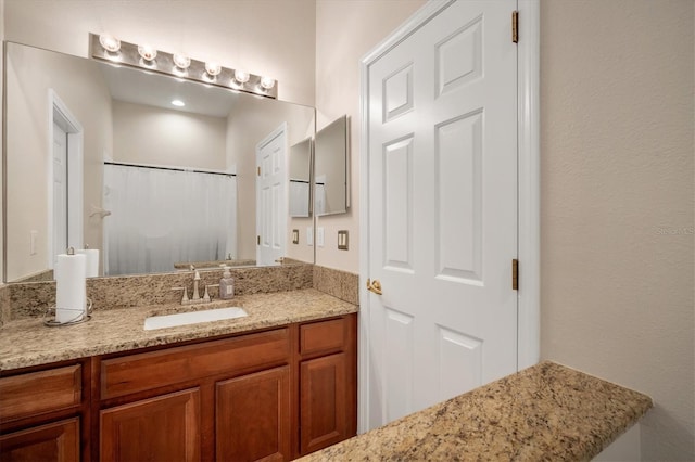 bathroom featuring curtained shower and vanity