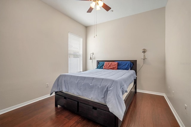 bedroom with ceiling fan, baseboards, and wood finished floors