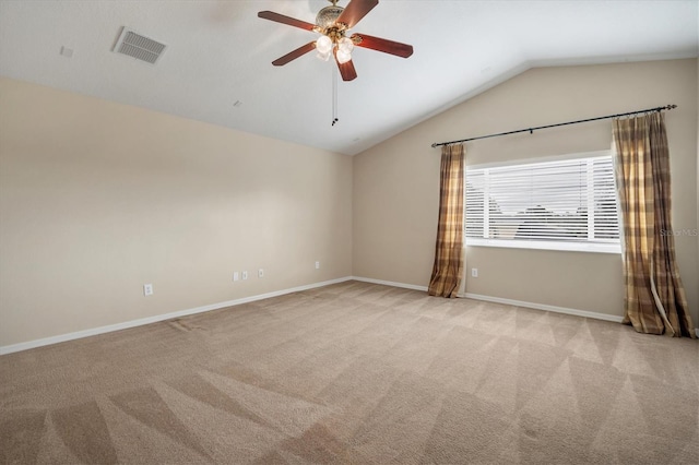 empty room featuring carpet floors, lofted ceiling, visible vents, and baseboards