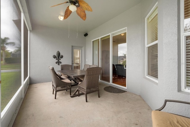 sunroom / solarium with a ceiling fan