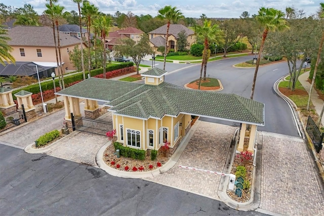 view of home's community featuring driveway, a gate, a residential view, and fence