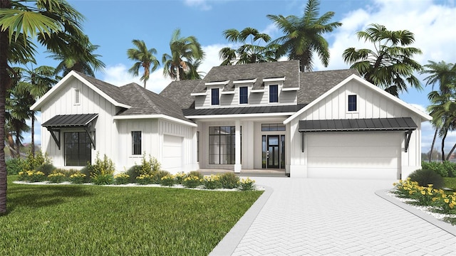 modern farmhouse style home featuring a garage, metal roof, decorative driveway, a front lawn, and board and batten siding