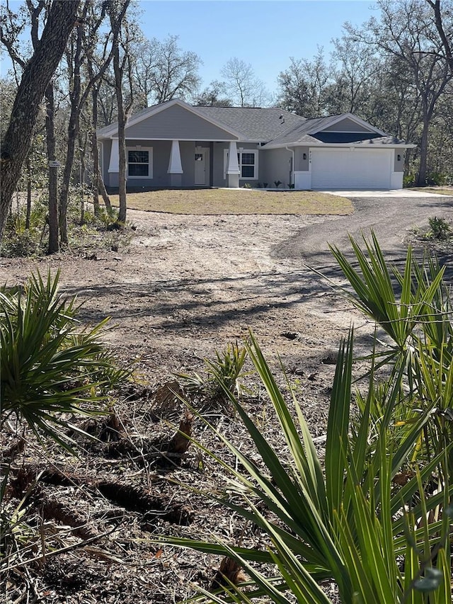 view of front of home with driveway, an attached garage, and stucco siding