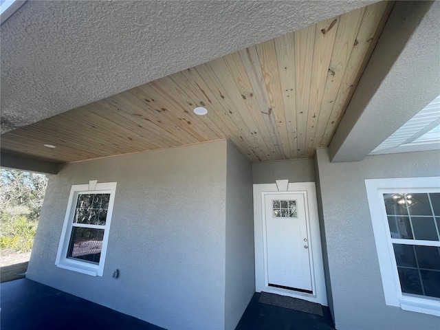 entrance to property featuring stucco siding