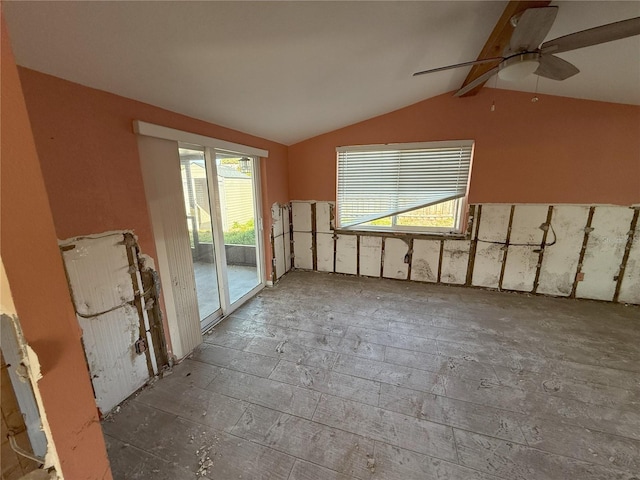 unfurnished room with vaulted ceiling with beams and a ceiling fan