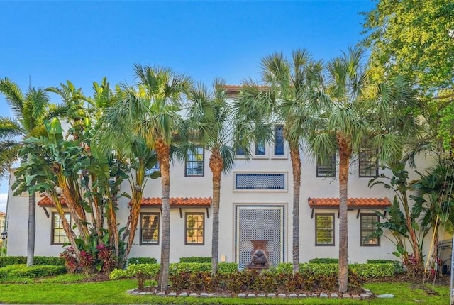 view of front of property featuring a tile roof and stucco siding