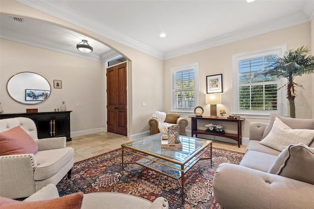 living area with baseboards, visible vents, arched walkways, stone finish floor, and crown molding