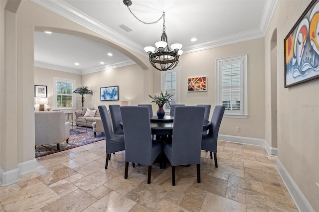 dining room with arched walkways, a notable chandelier, baseboards, stone tile flooring, and crown molding