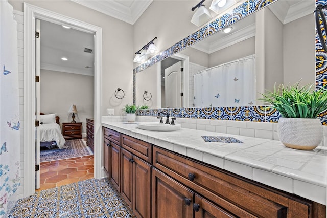 ensuite bathroom featuring tile patterned flooring, visible vents, crown molding, and vanity