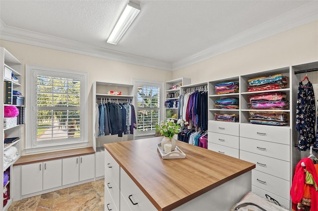 spacious closet with stone finish floor