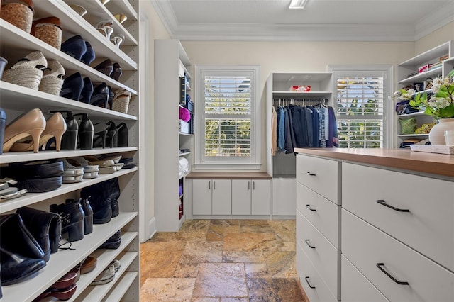 spacious closet with stone tile flooring