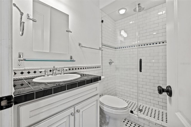 bathroom with a stall shower, vanity, and toilet