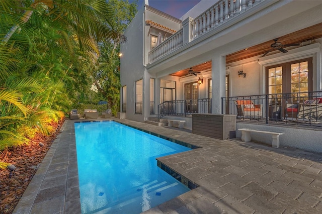 pool featuring a patio, french doors, and a ceiling fan