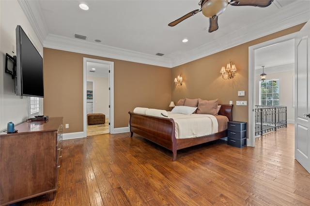 bedroom featuring ornamental molding, hardwood / wood-style flooring, and visible vents