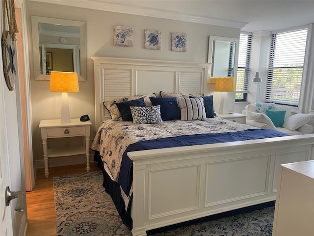 bedroom featuring ornamental molding and light wood-style floors