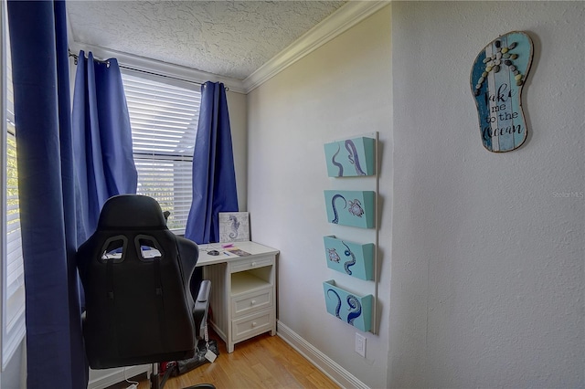 office area featuring light wood-style floors, a textured ceiling, baseboards, and crown molding