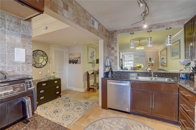 kitchen with a sink, dark stone countertops, visible vents, and stainless steel dishwasher