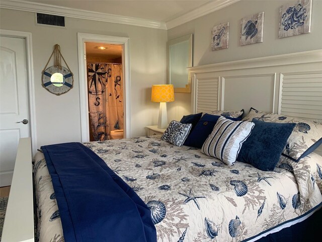 bedroom featuring visible vents, crown molding, and ensuite bathroom