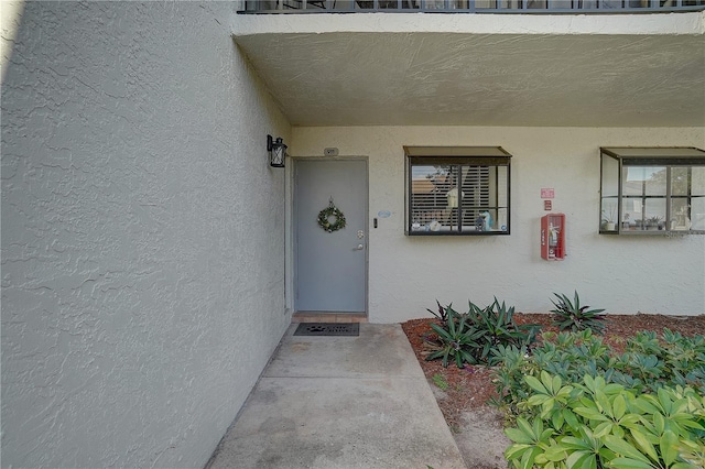 entrance to property with stucco siding