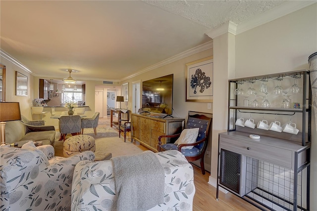 living area featuring crown molding and light wood-style flooring