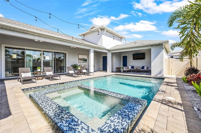 view of swimming pool featuring a pool with connected hot tub, a gate, an outdoor hangout area, and a patio