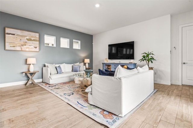 living room with light wood-style flooring and baseboards