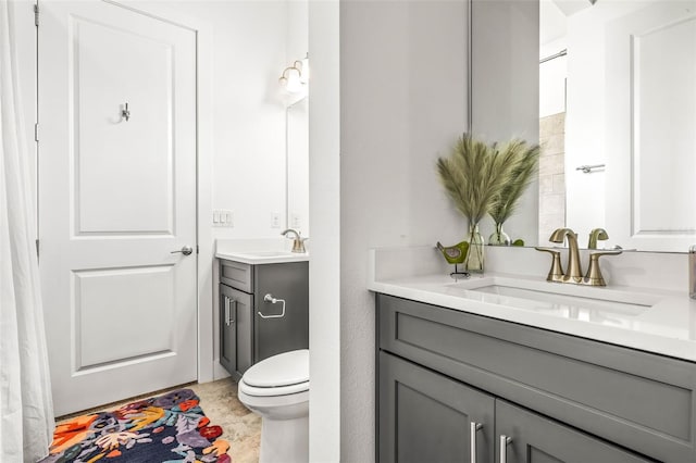 bathroom featuring toilet and vanity